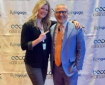 Doctor Snow smiling with a man in a suit at a professional dental event