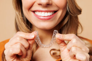 Patient smiling with Invisalign aligner